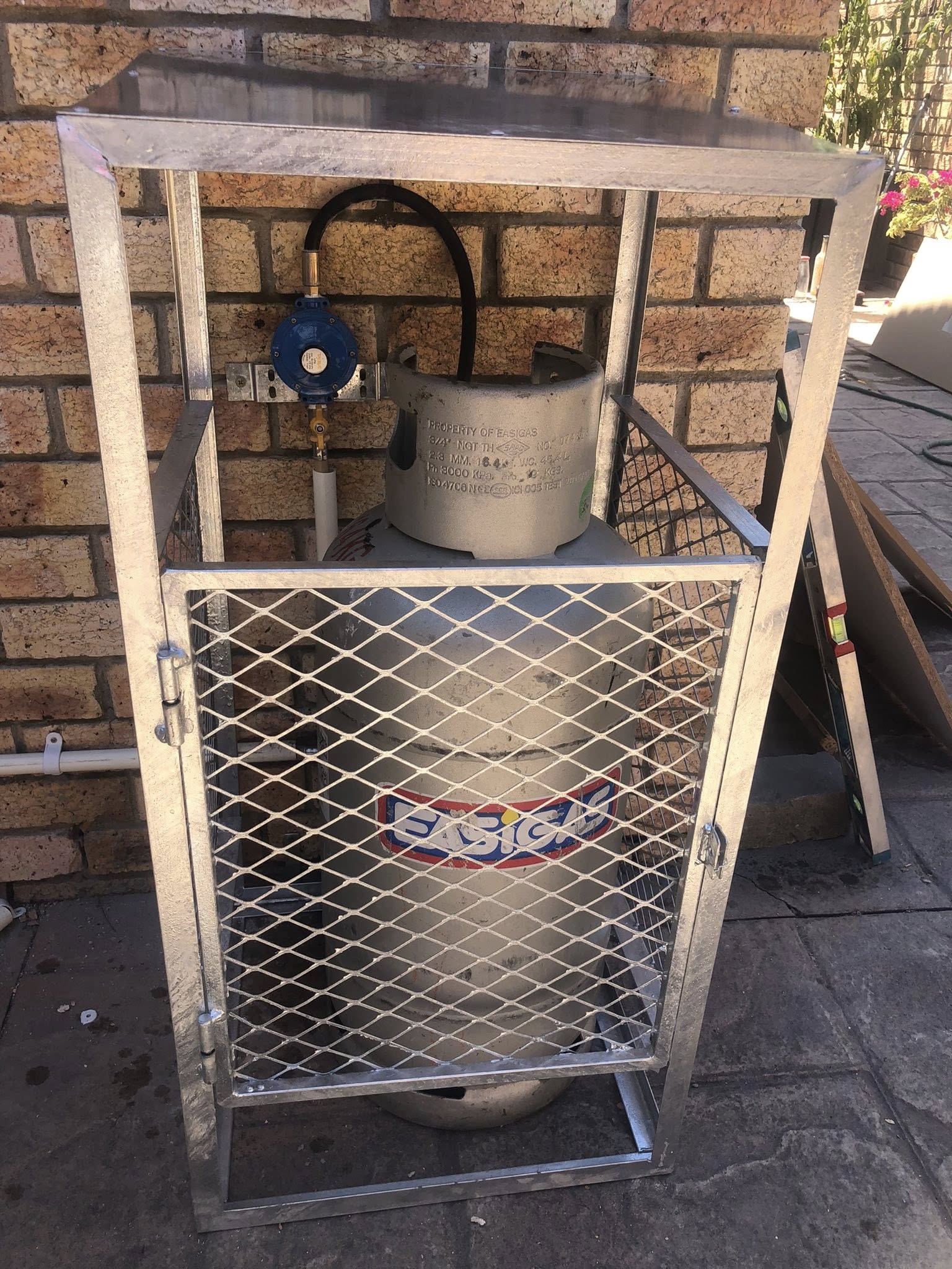 Residential LPG gas cage with cylinder, regulator and compliant installation in Cape Town.