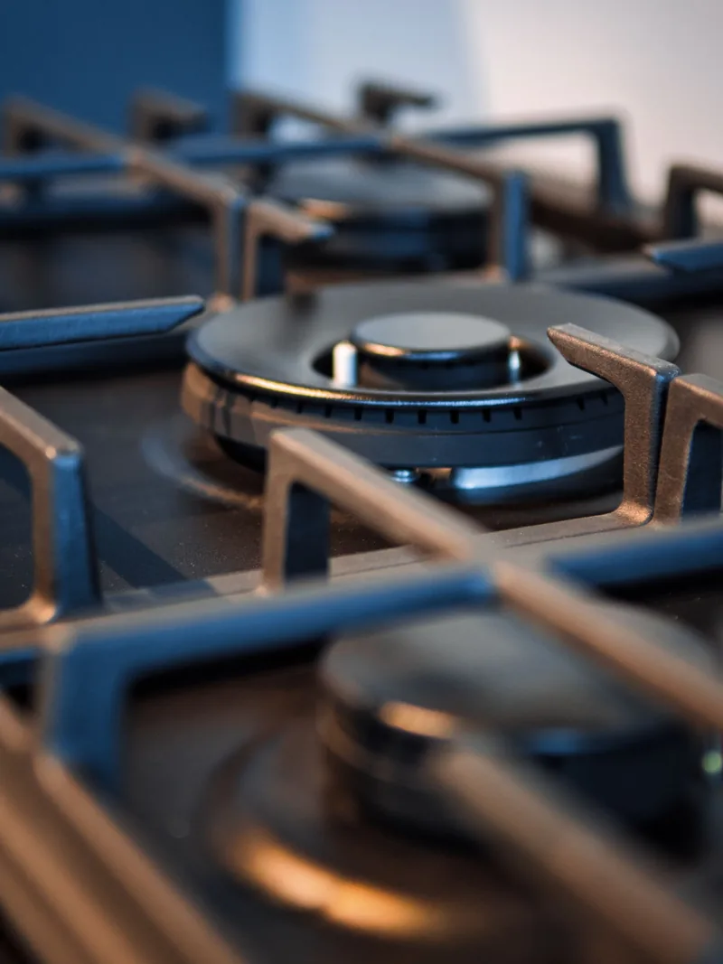 Close-up of a gas hob burner crown and cast iron trivet