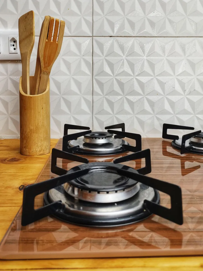 Close-up of gas burner crowns and cast iron trivets on a fitted hob