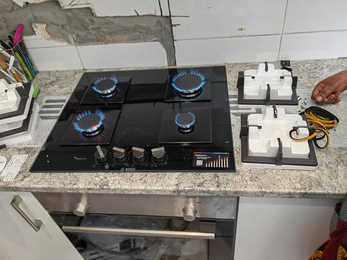 Gas hob installed by Red Flame Gas Supplier in Cape Town with all four burners lit and burning blue after the pressure test