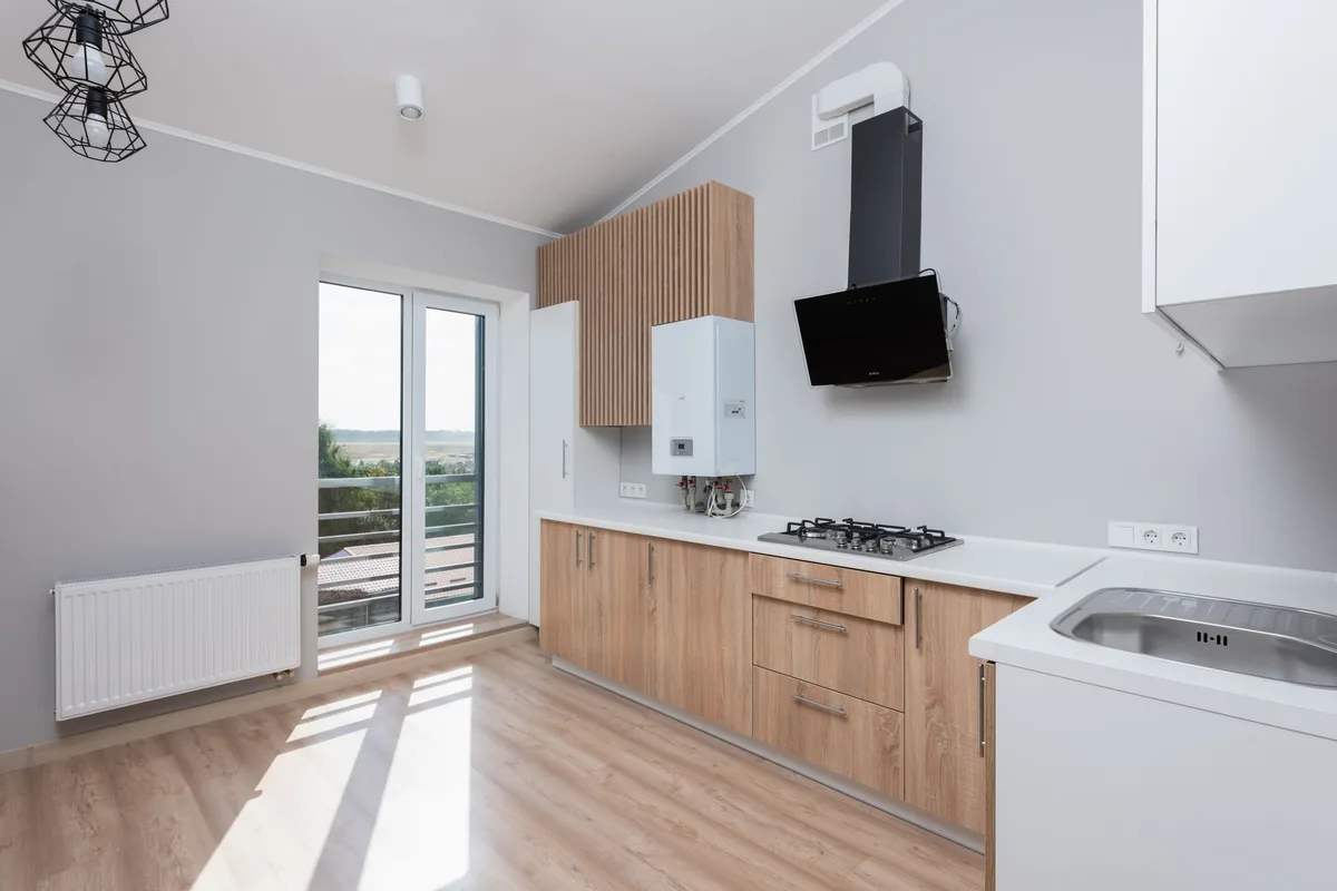 Modern kitchen with a stainless gas hob and a wall-mounted gas water heater